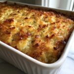 Close-up of baked french onion butter rice casserole with a golden brown, crispy, cheesy topping.