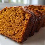 Close-up view showing the moist, dense crumb texture of sliced pumpkin bread.