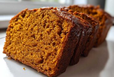 Close-up view showing the moist, dense crumb texture of sliced pumpkin bread.