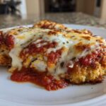 Close-up of a breaded chicken breast topped with marinara sauce and melted mozzarella cheese, representing Easy chicken Parmesan.