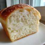 Close-up of the incredibly soft and fluffy interior crumb structure of homemade japanese milk bread.