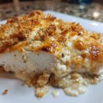 A cross-section slice of juicy Garlic Parmesan Chicken Bake with a golden, cheesy, and crunchy topping.