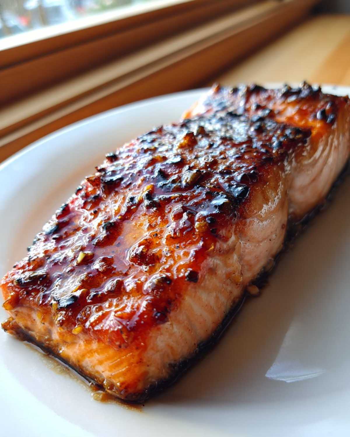 Close-up of a perfectly cooked salmon recipe fillet with a sticky, caramelized glaze.