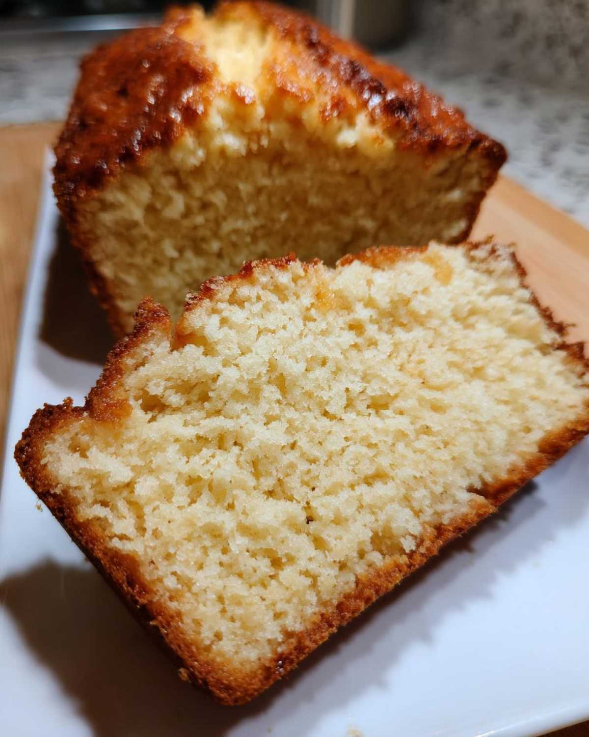 Close-up showing the soft, airy crumb texture of a slice of homemade beer bread with a golden-brown crust.