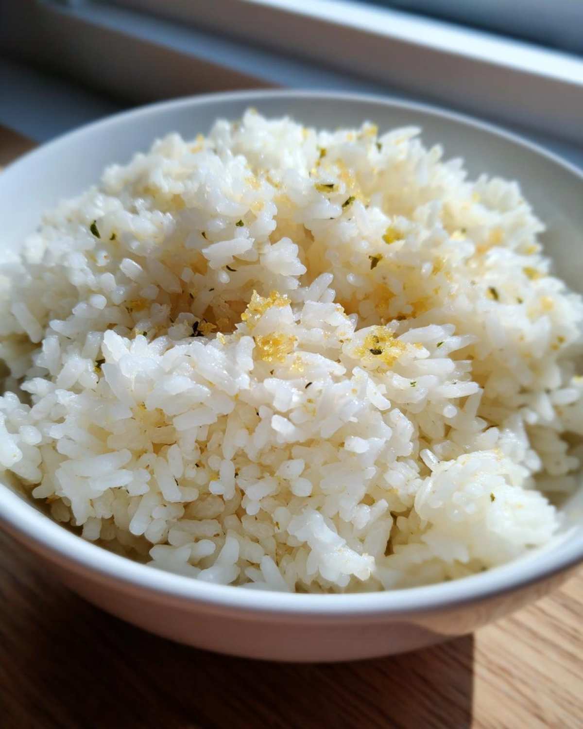 Close-up of fluffy white rice seasoned with garlic and herbs, ready to eat butter rice.