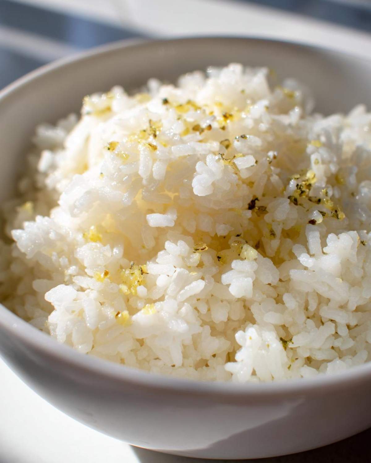 Close-up of fluffy white rice seasoned with garlic and herbs, ready to eat, our perfect butter rice.