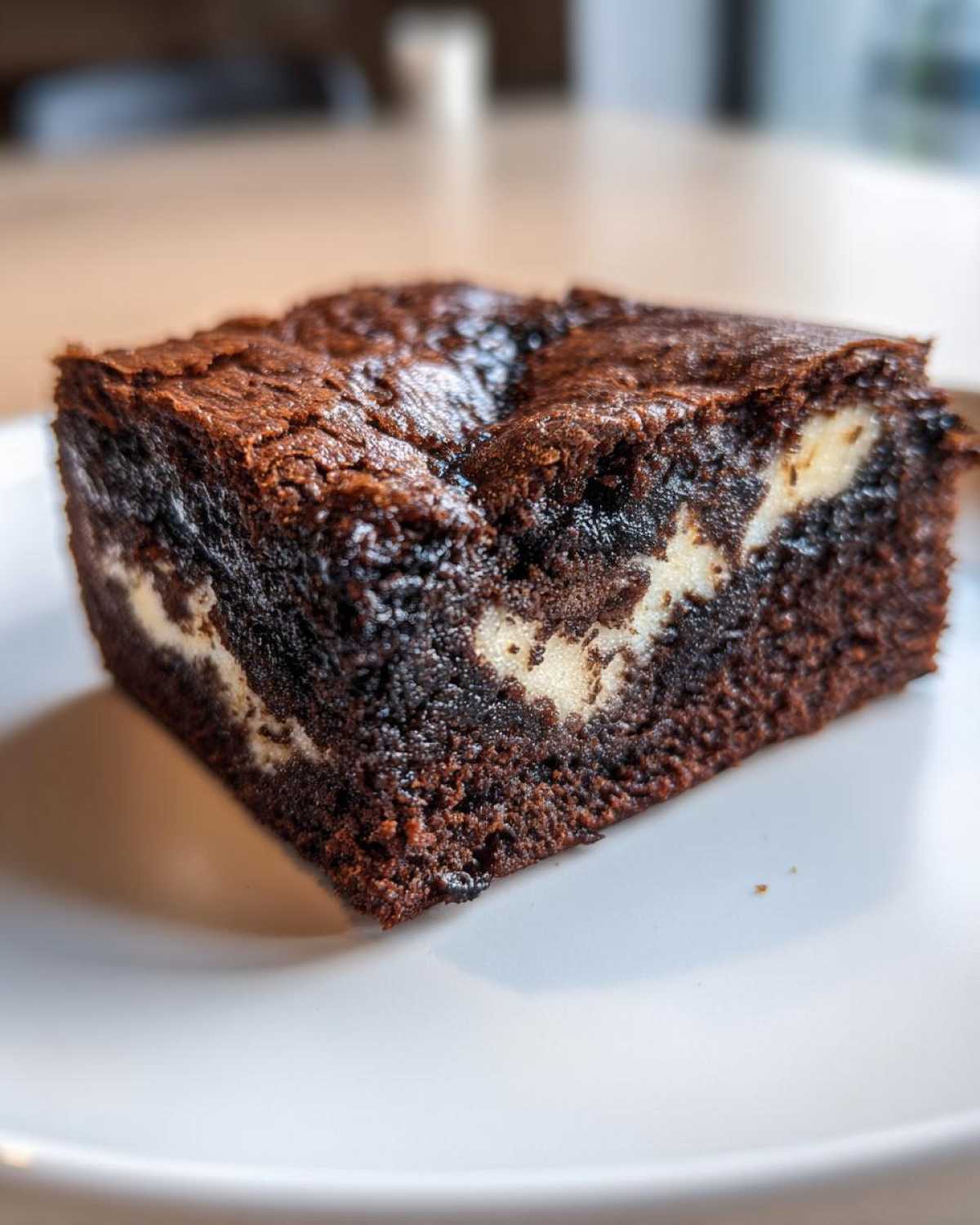 Close-up of a rich, dark chocolate Black Sesame Mochi Brownies square showing a chewy texture and white filling swirls.