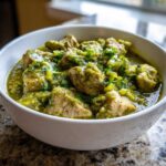 Close-up of tender pork chunks smothered in vibrant green Chile Verde Pork Stew with Tomatillos, garnished with fresh cilantro.