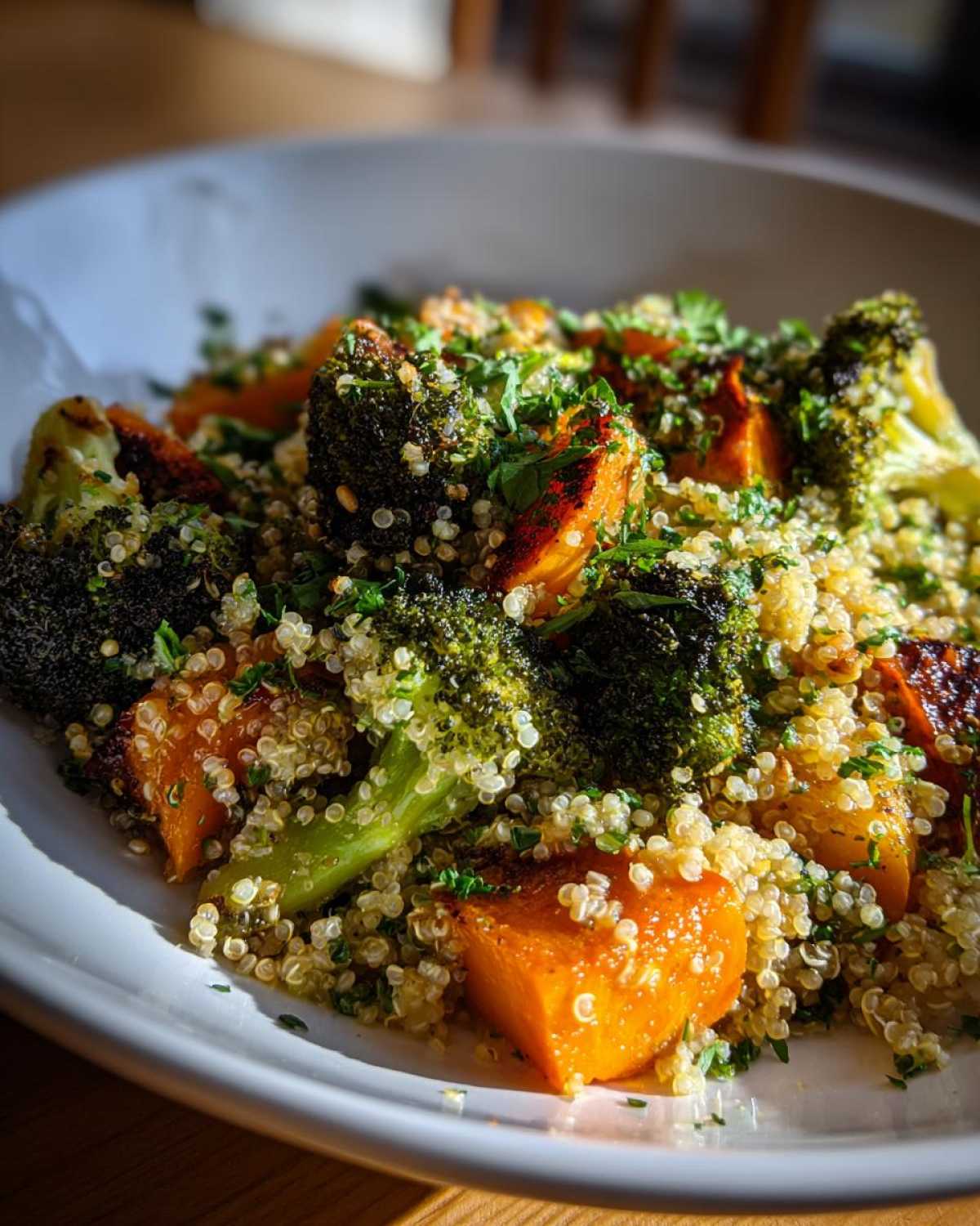 Close-up of Herbed Quinoa with Roasted Vegetables, featuring roasted sweet potato chunks and broccoli florets.
