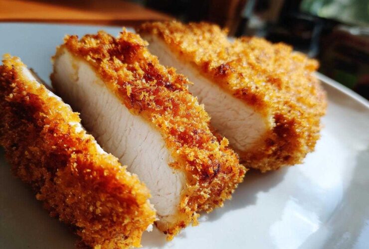 Close-up of three thick slices of golden brown Katsu Curry Sandwich Cutlets showing juicy white meat inside.