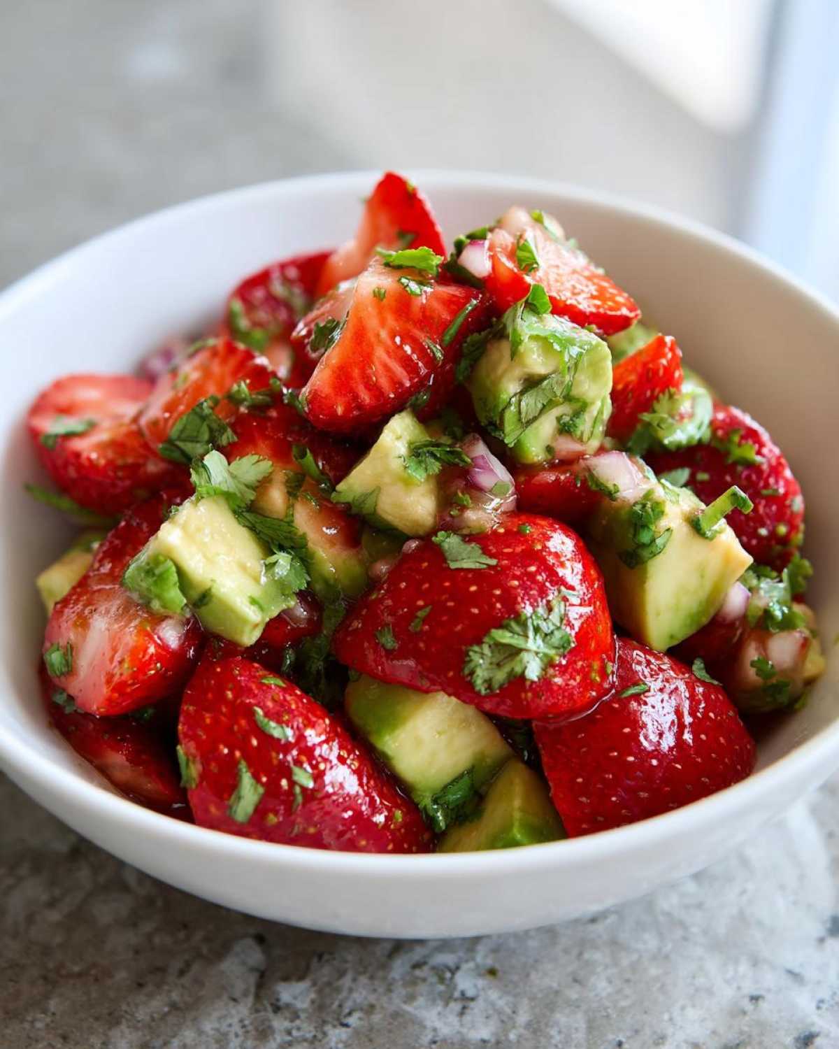 Close-up of vibrant Strawberry Avocado Salsa with Lime, featuring chunks of fresh strawberries and avocado tossed with cilantro.